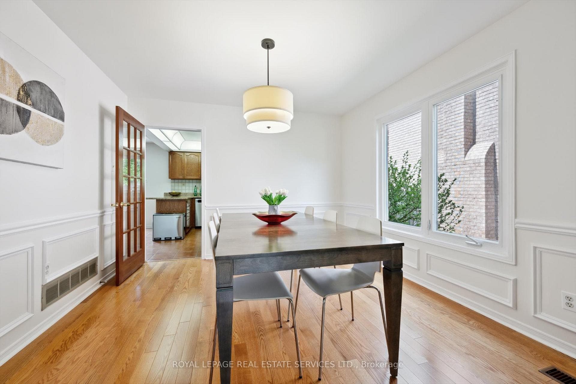 Dining Room with Wainscoting and Hardwood Flooring
