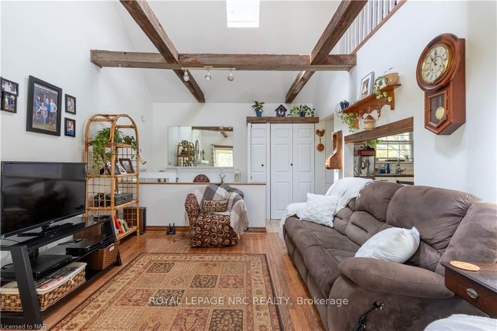 Exposed Beams and Skylights Illuminate the Living