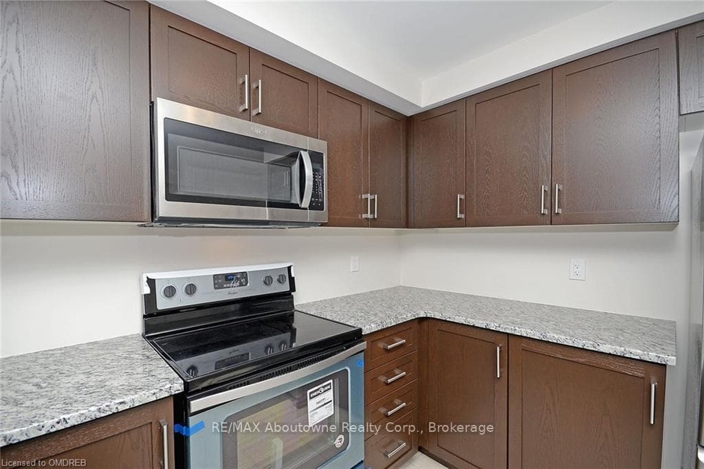 Kitchen featuring light stone countertops and stai