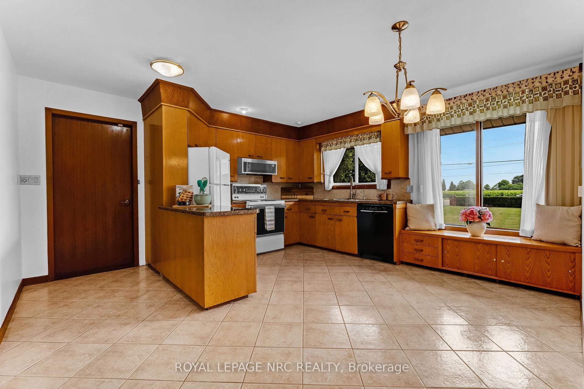 Eat-in kitchen with gleaming tile floor.