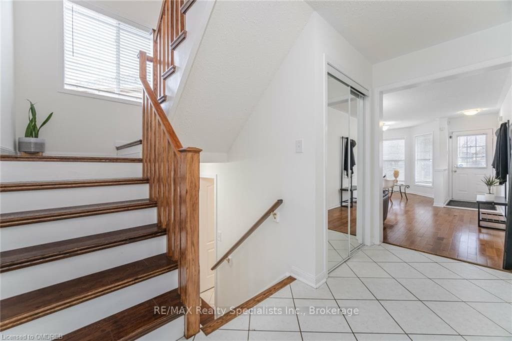 Staircase with hardwood / wood-style flooring