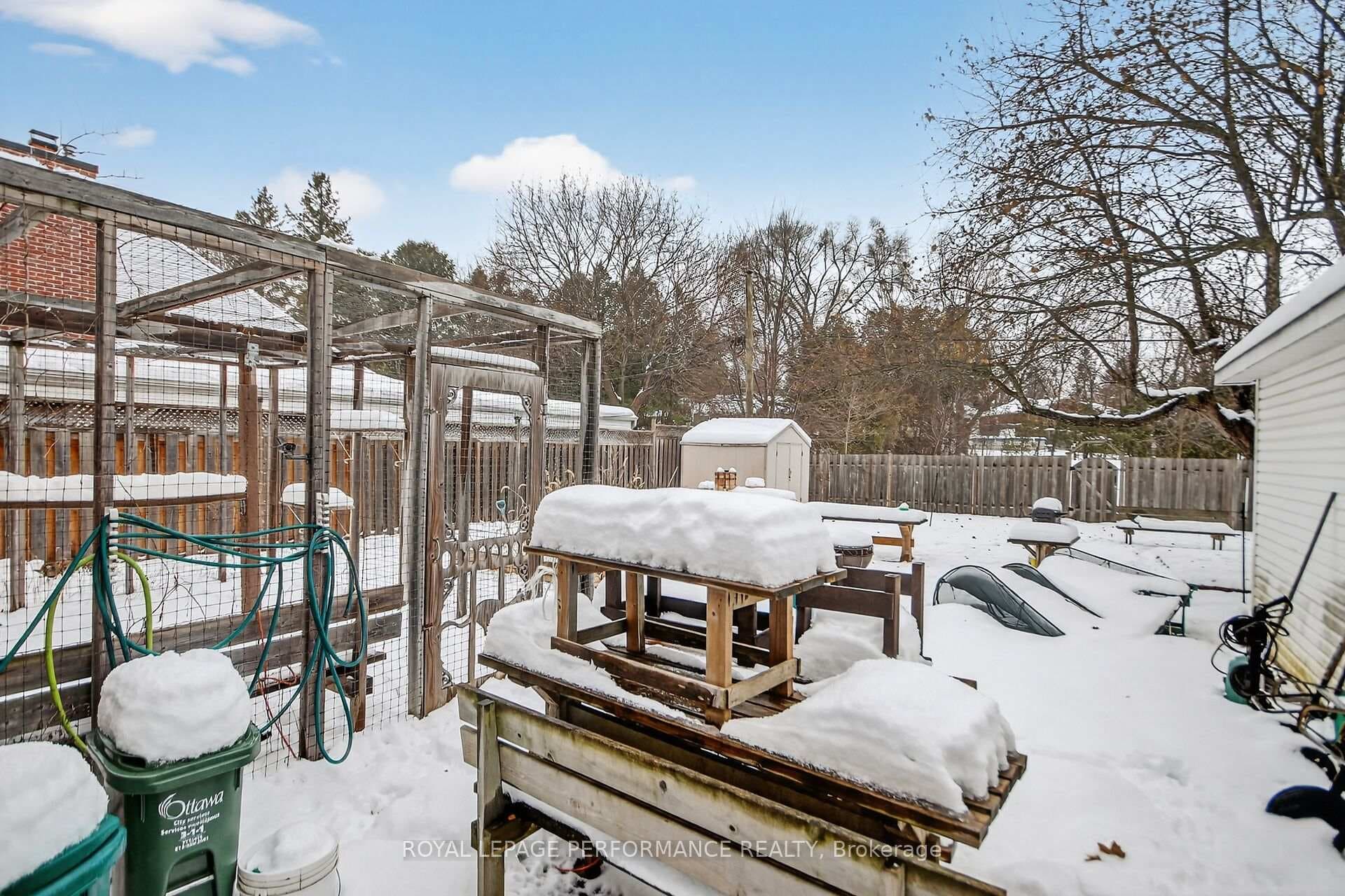 Storage shed, plus screened in enclosure.
