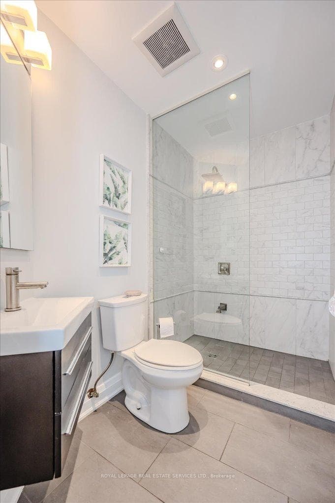 main floor bathroom with marble shower enclosure