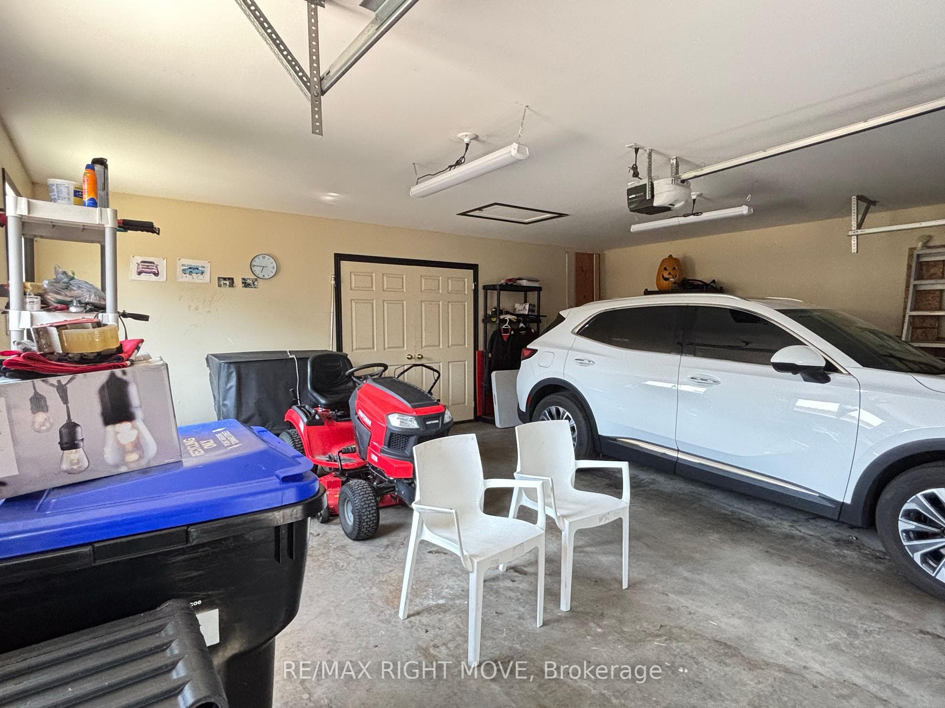 Garage showing doors to bonus room