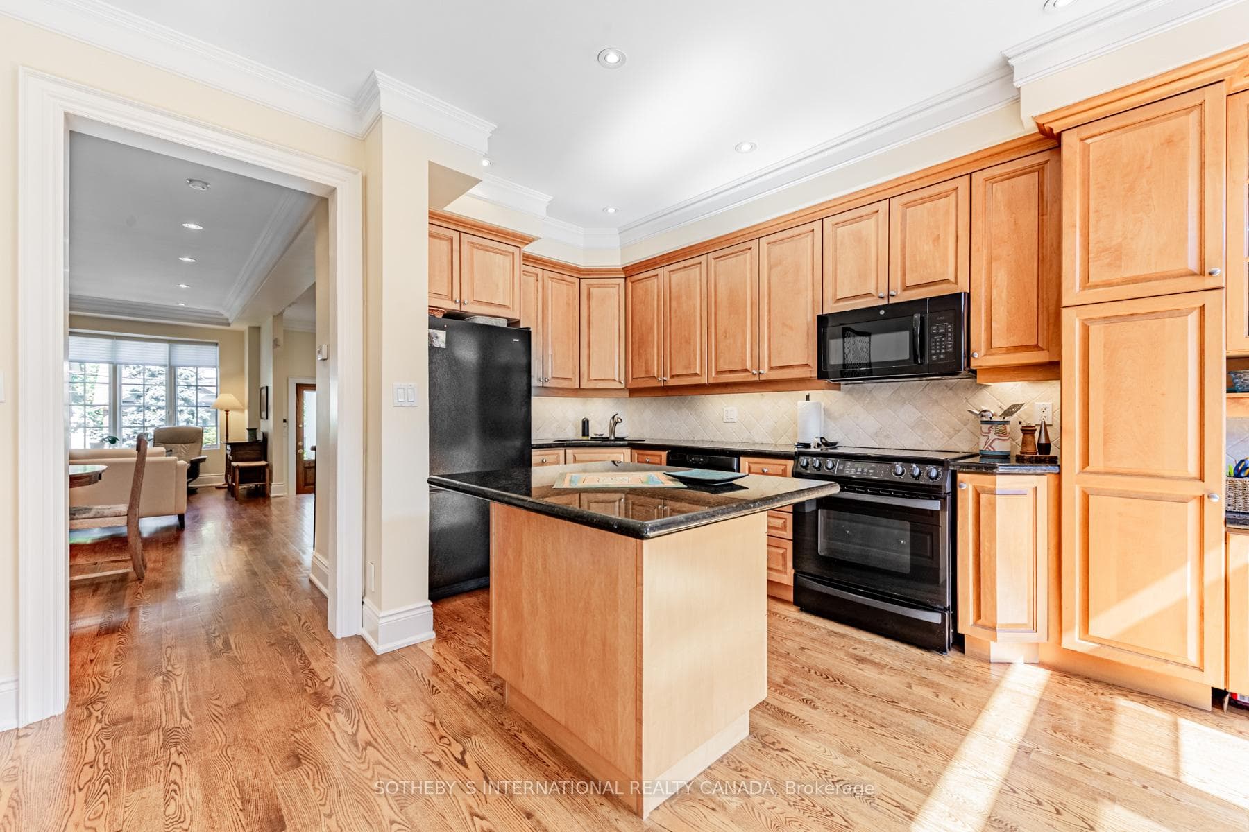 Eat-in kitchen w/ granite island & breakfast area.