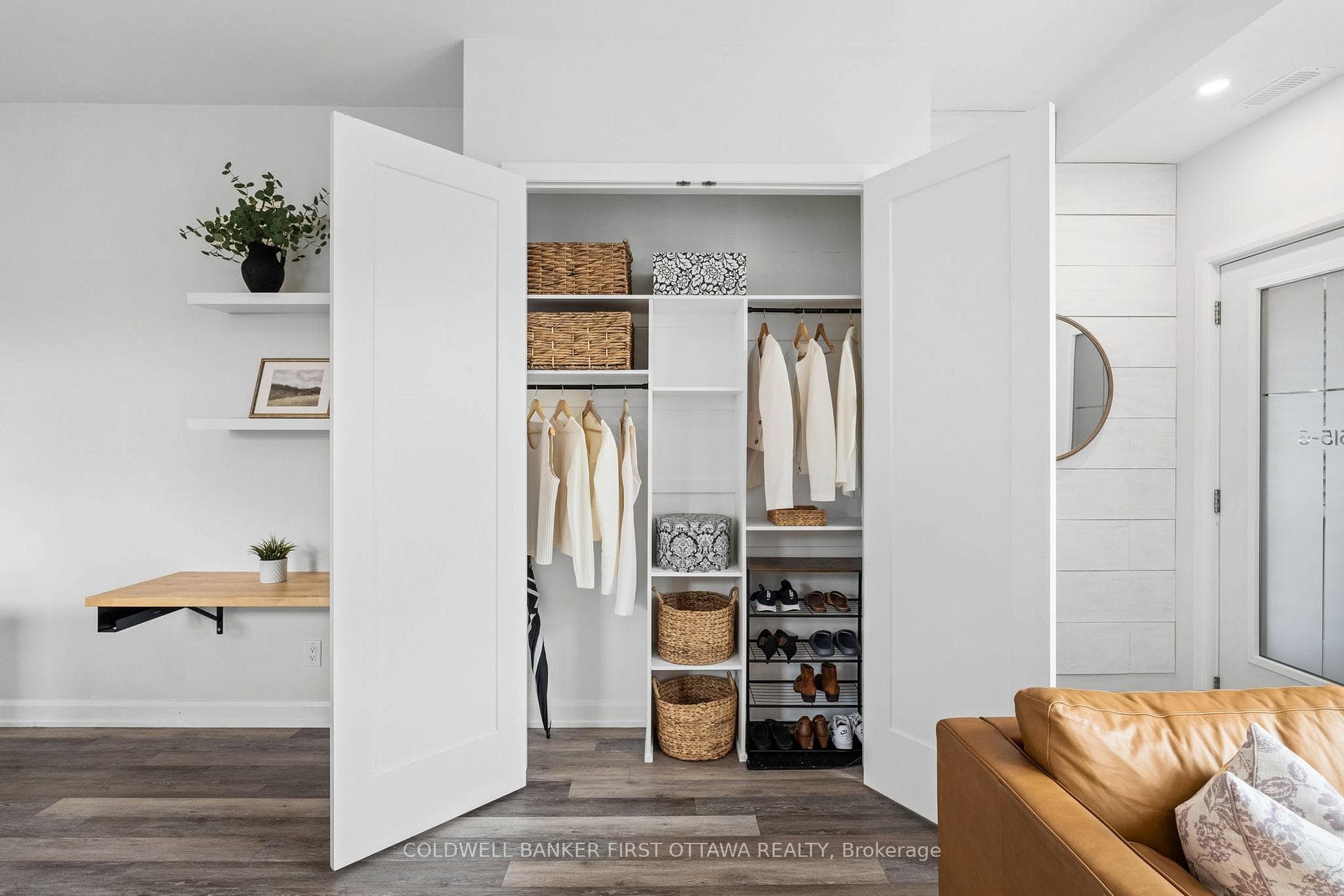 Dbl door front hall closet w/ custom shelving.