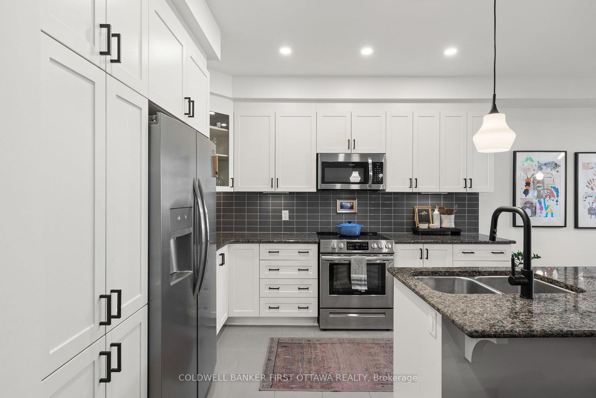 Tile backsplash w floor to ceiling cabinets.