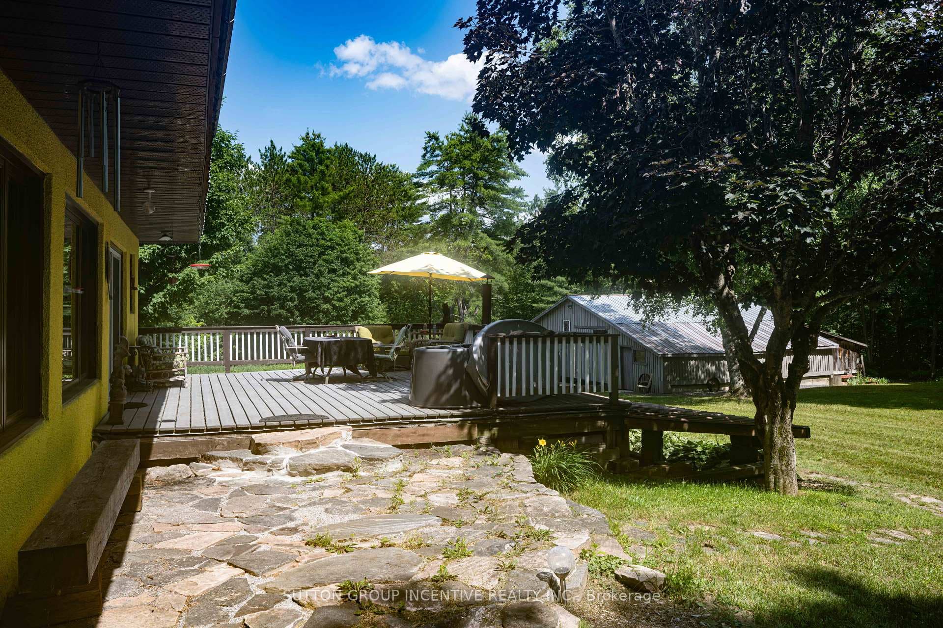 Large deck off eat in kitchen & stone patio