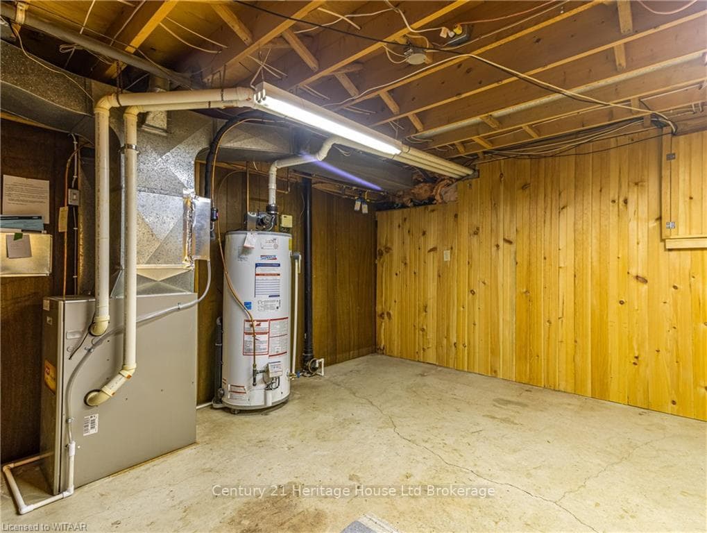 Basement with gas water heater, heating unit, and