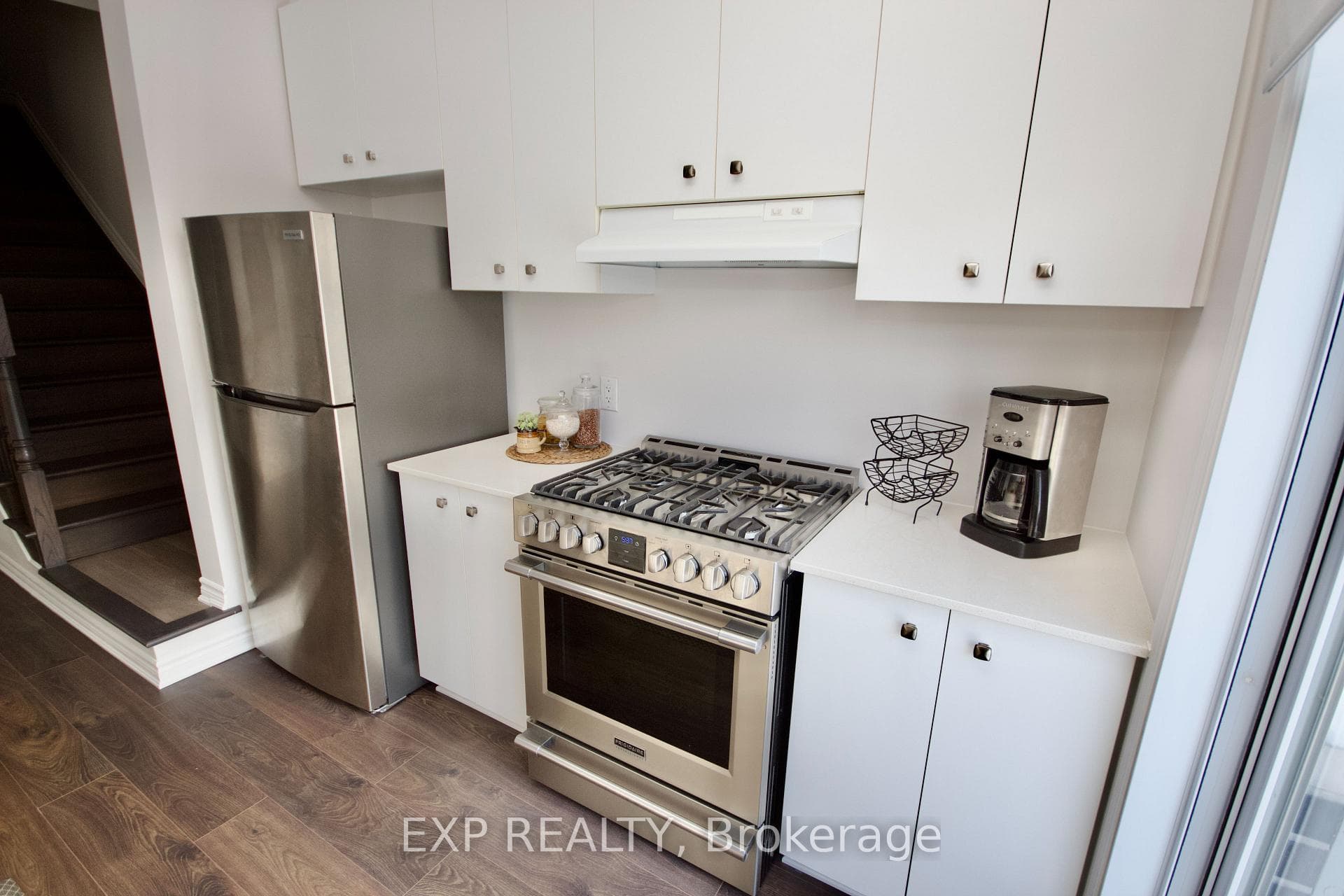 Clean white kitchen with gas stove |appliances inc