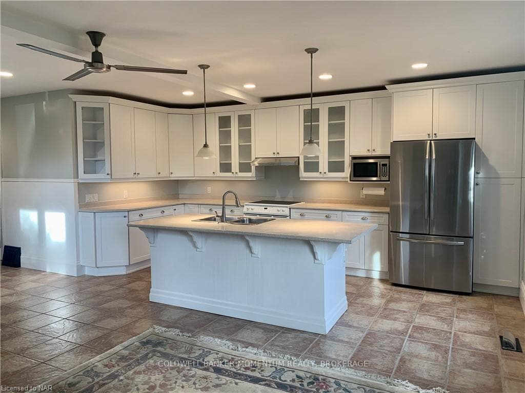 Kitchen featuring sink, a breakfast bar, appliance