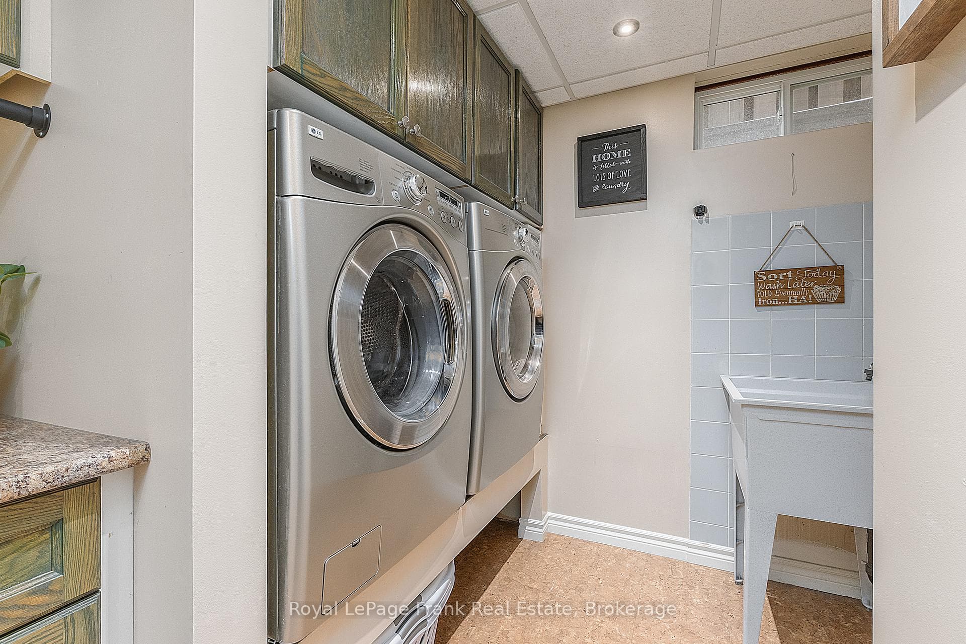 Laundry room has folding table & custom cabinets