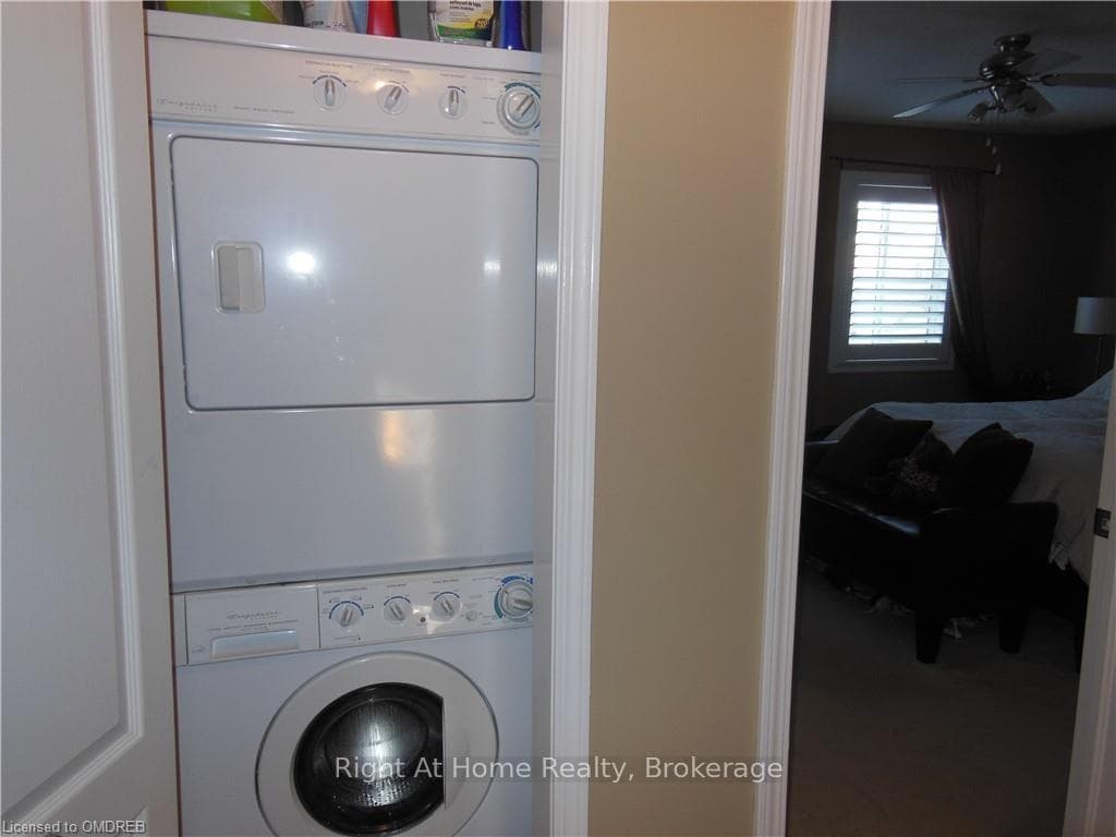 Clothes washing area featuring ceiling fan and sta