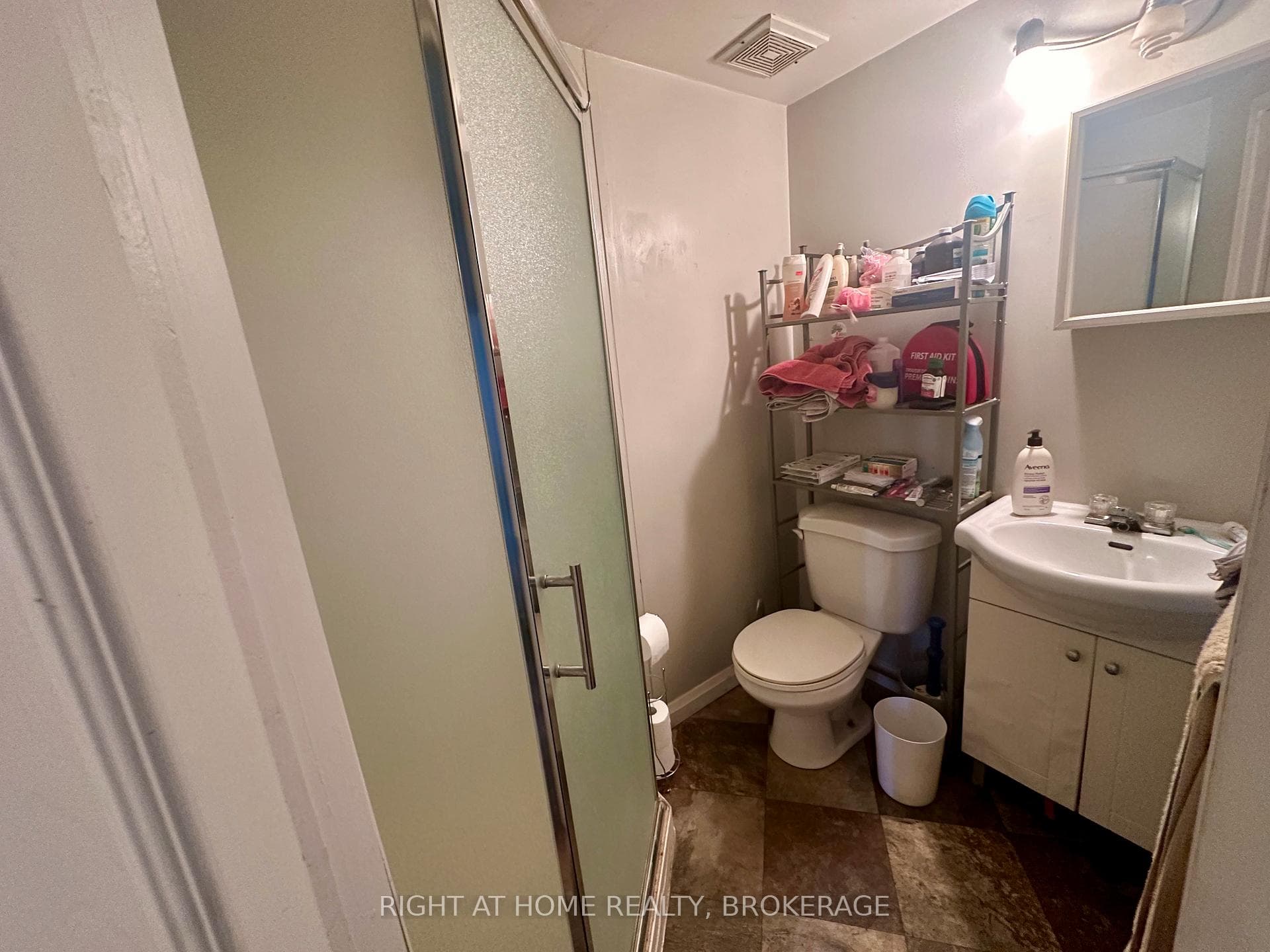 Bachelor unit bath toilet, vanity, walk in shower