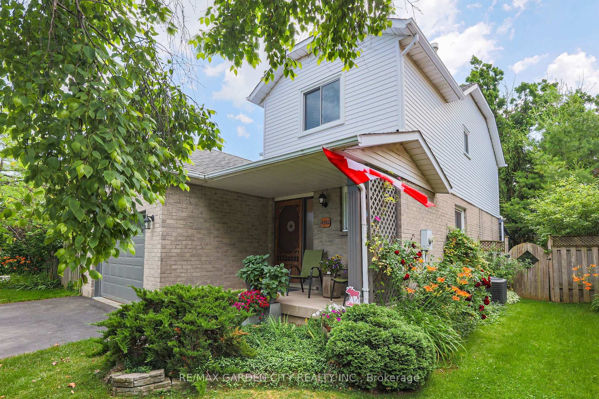 Side view of the home with nice gardens surroundin