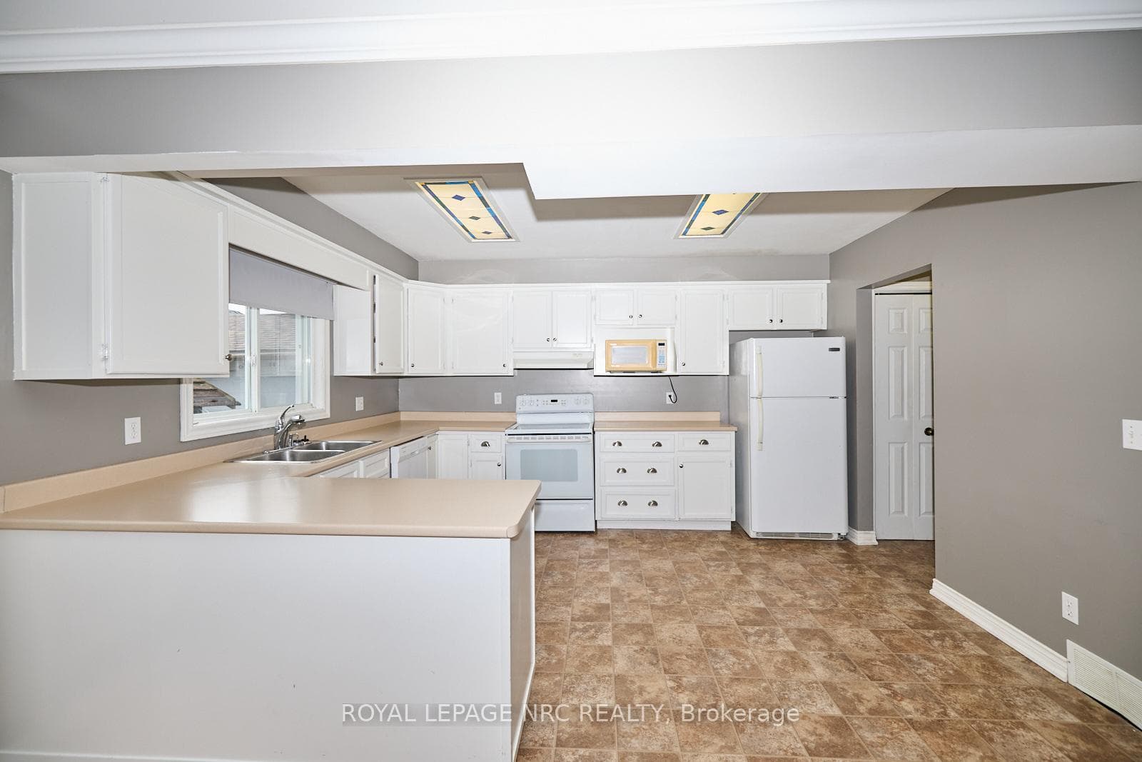 The good sized kitchen with double sink.