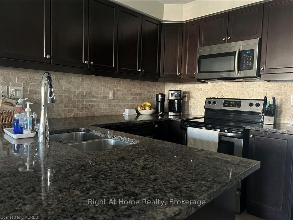 Kitchen with sink, backsplash, dark brown cabinets