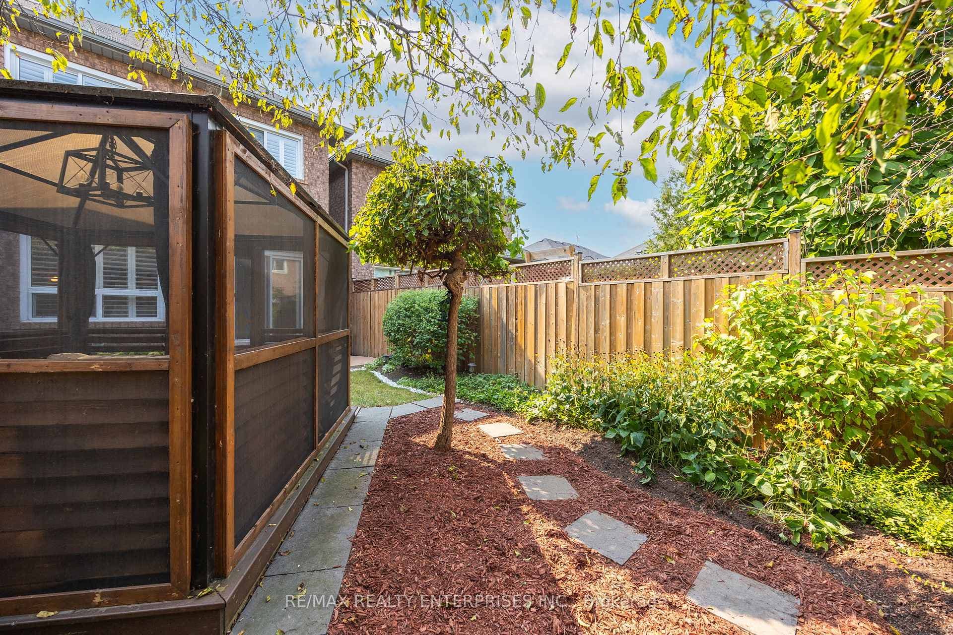 Landscaped backyard with screened-in gazebo