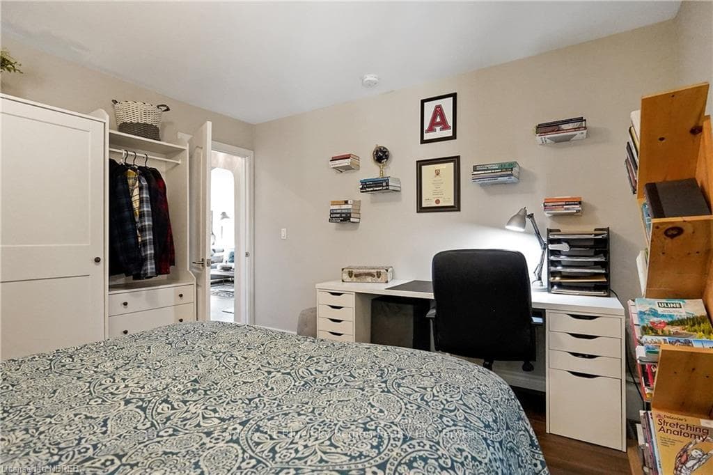 Bedroom with a closet and dark wood-type flooring