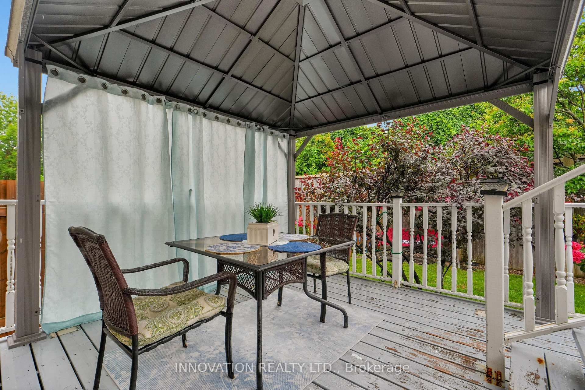 Lower level deck with gazebo and privacy curtain.