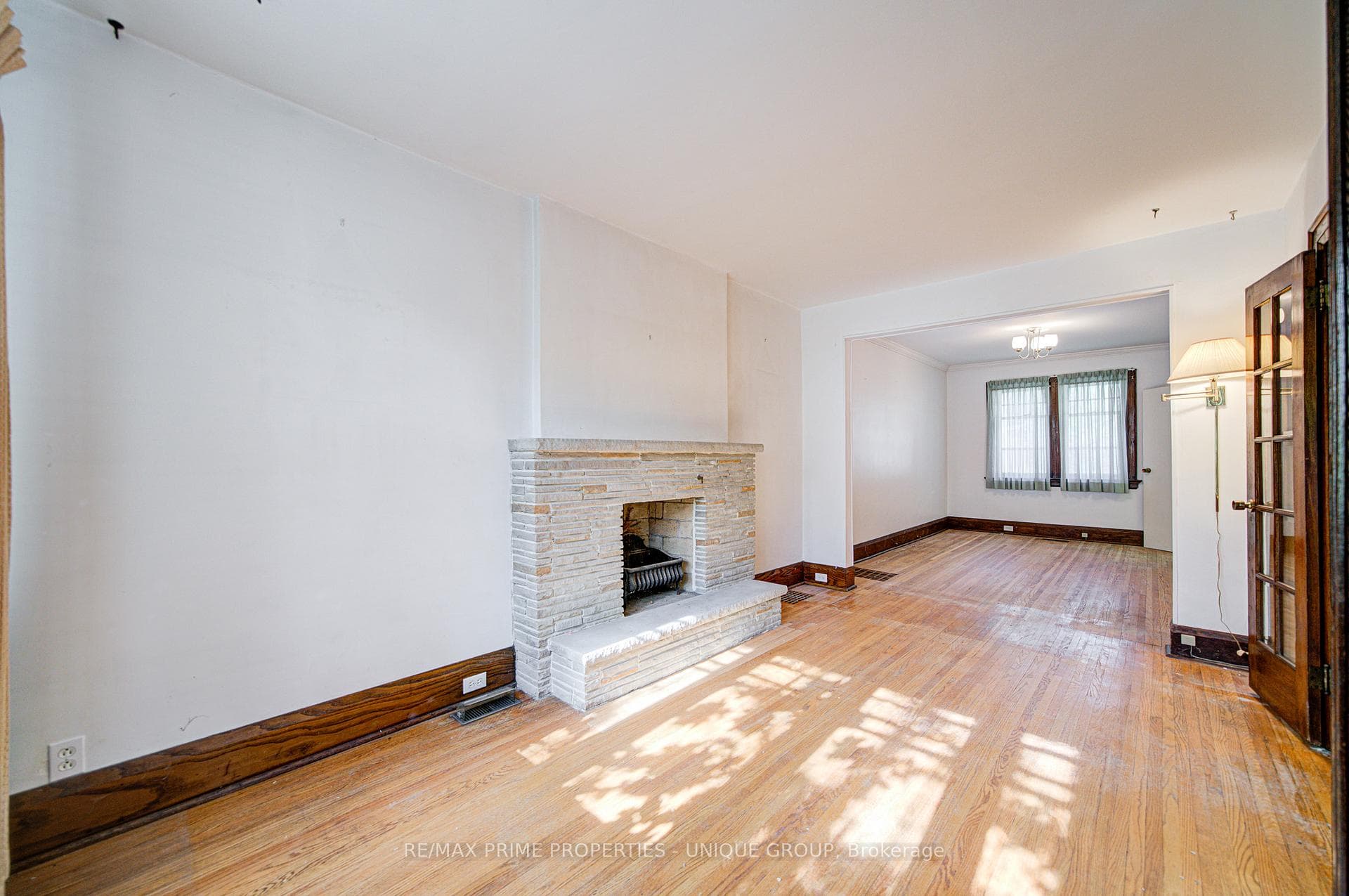 Living room fireplace w/dining room in background