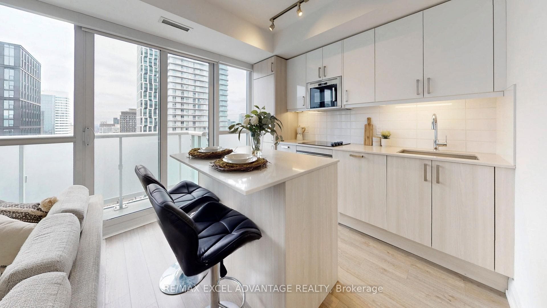 Sleek white kitchen with island seating