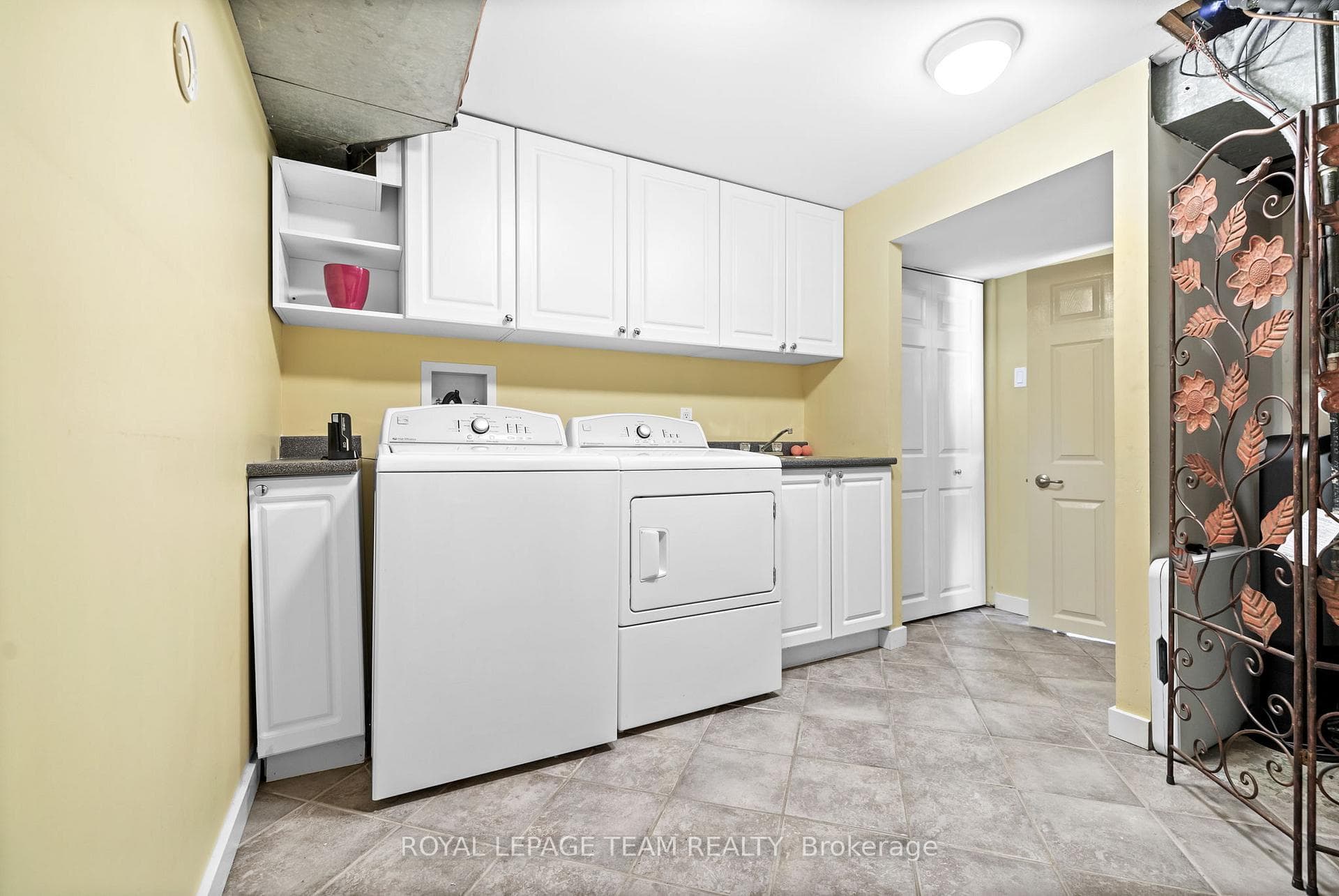 Lower level laundry room has lots of storage.