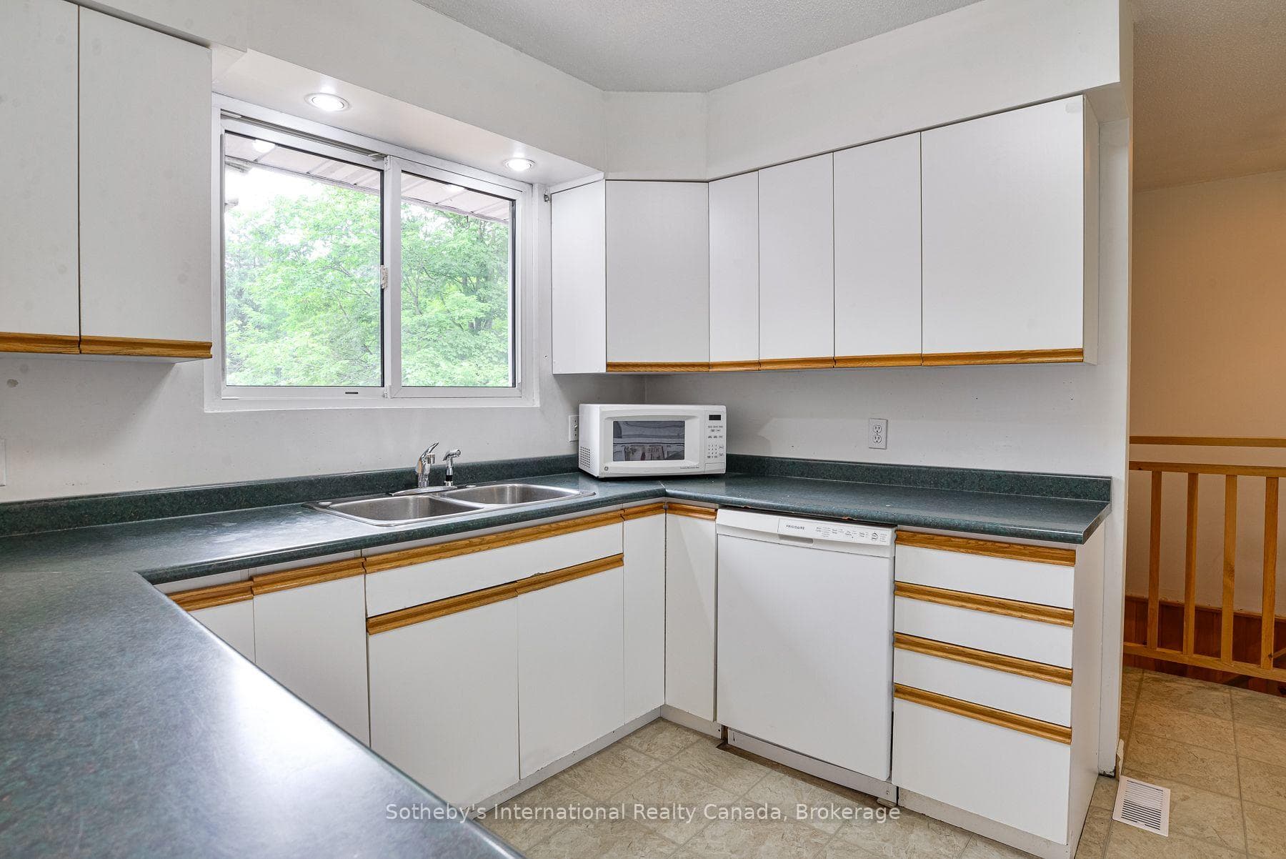 Kitchen overlooking spacious backyard.