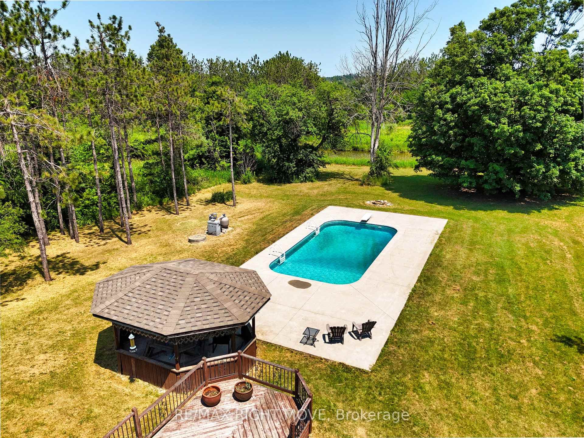 Salt water pool has a pool-side gazebo.