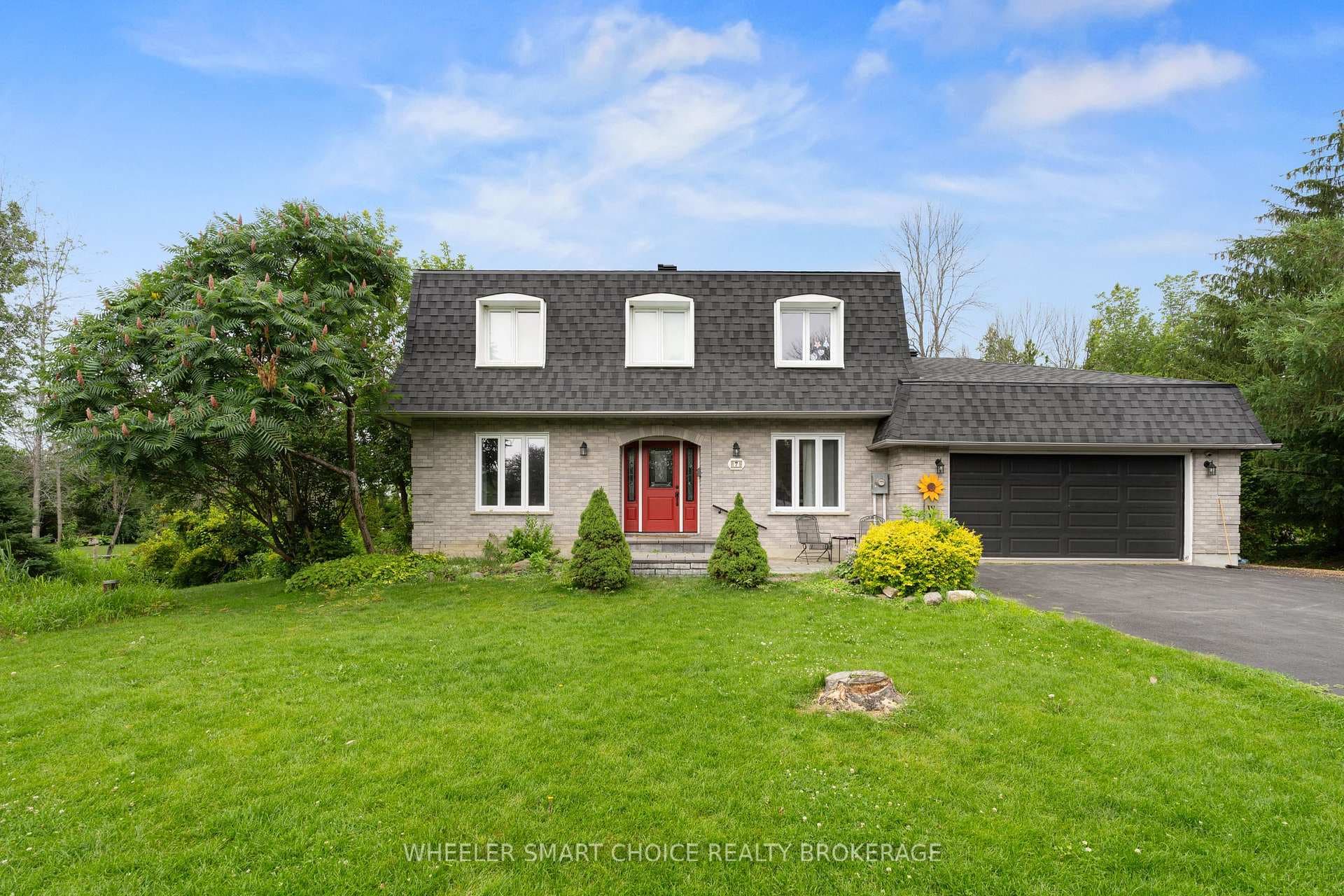 Featuring a distinctive mansard-style roofline