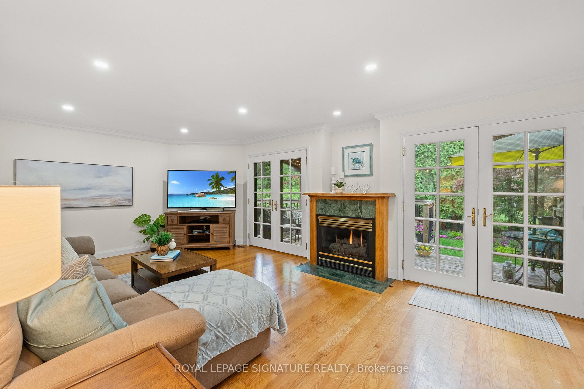 FRENCH DOORS ON EITHER SIDE OF GAS FIREPLACE